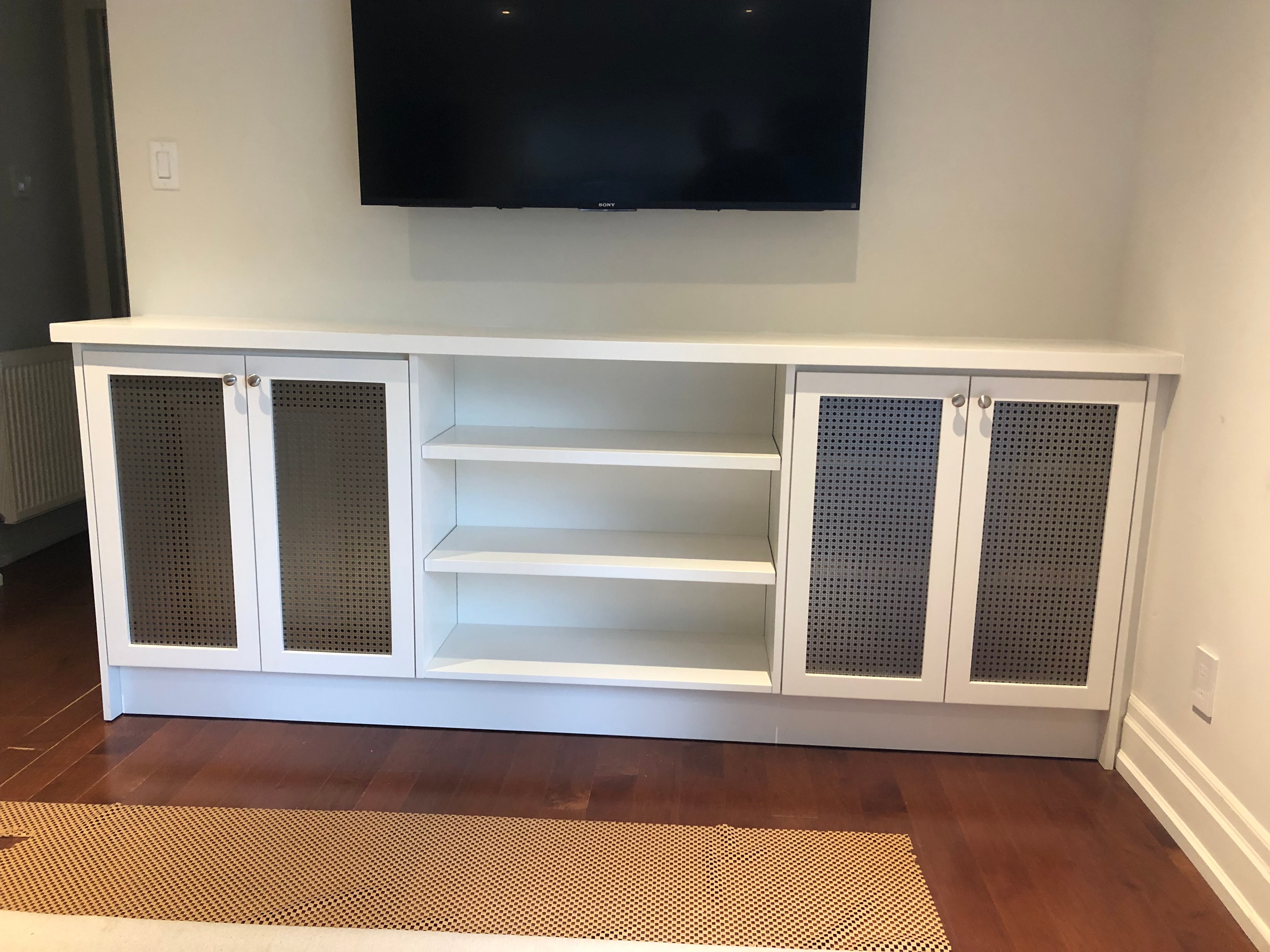 White media console with glass cabinet doors