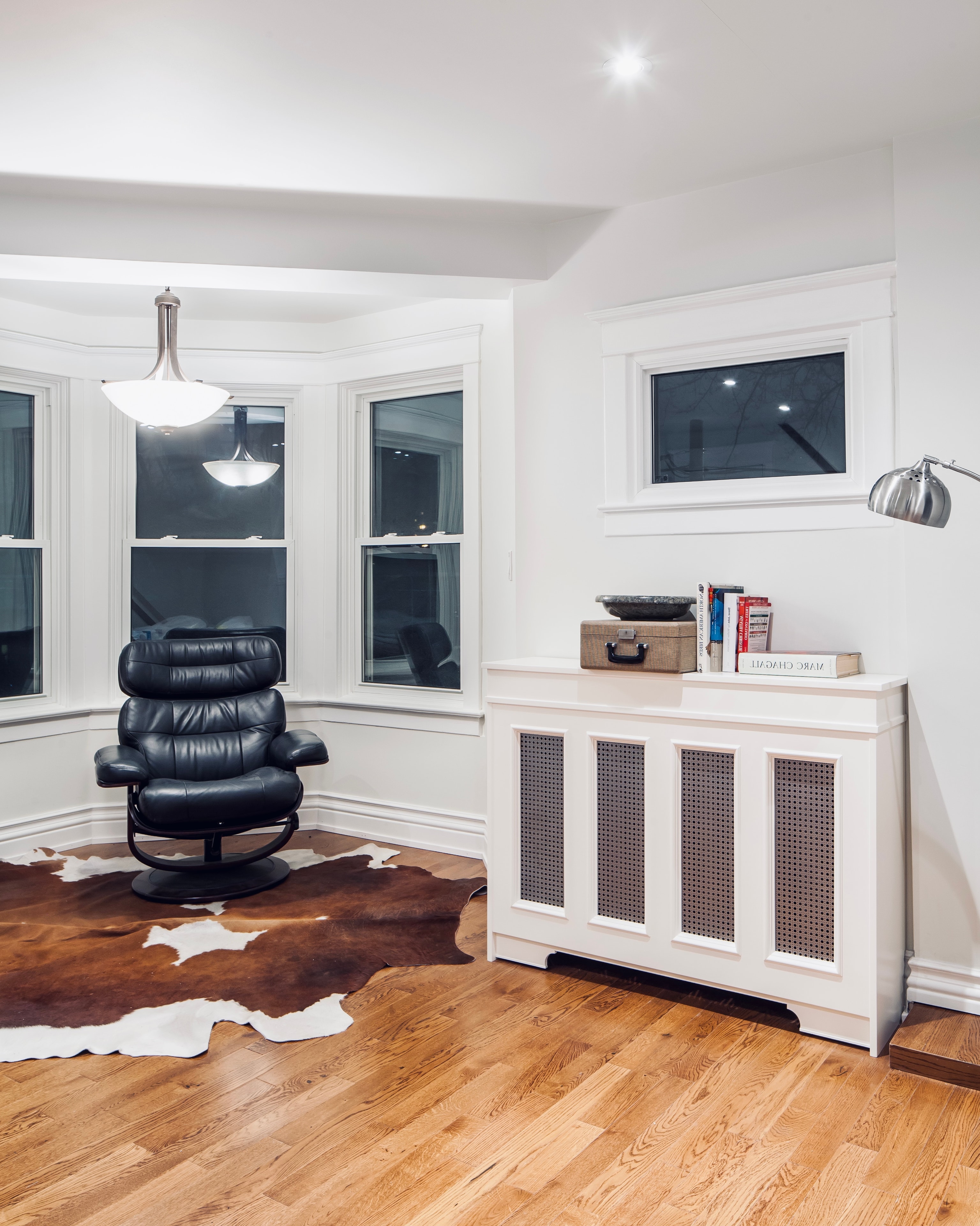 Custom radiator cover in living room with leather chair