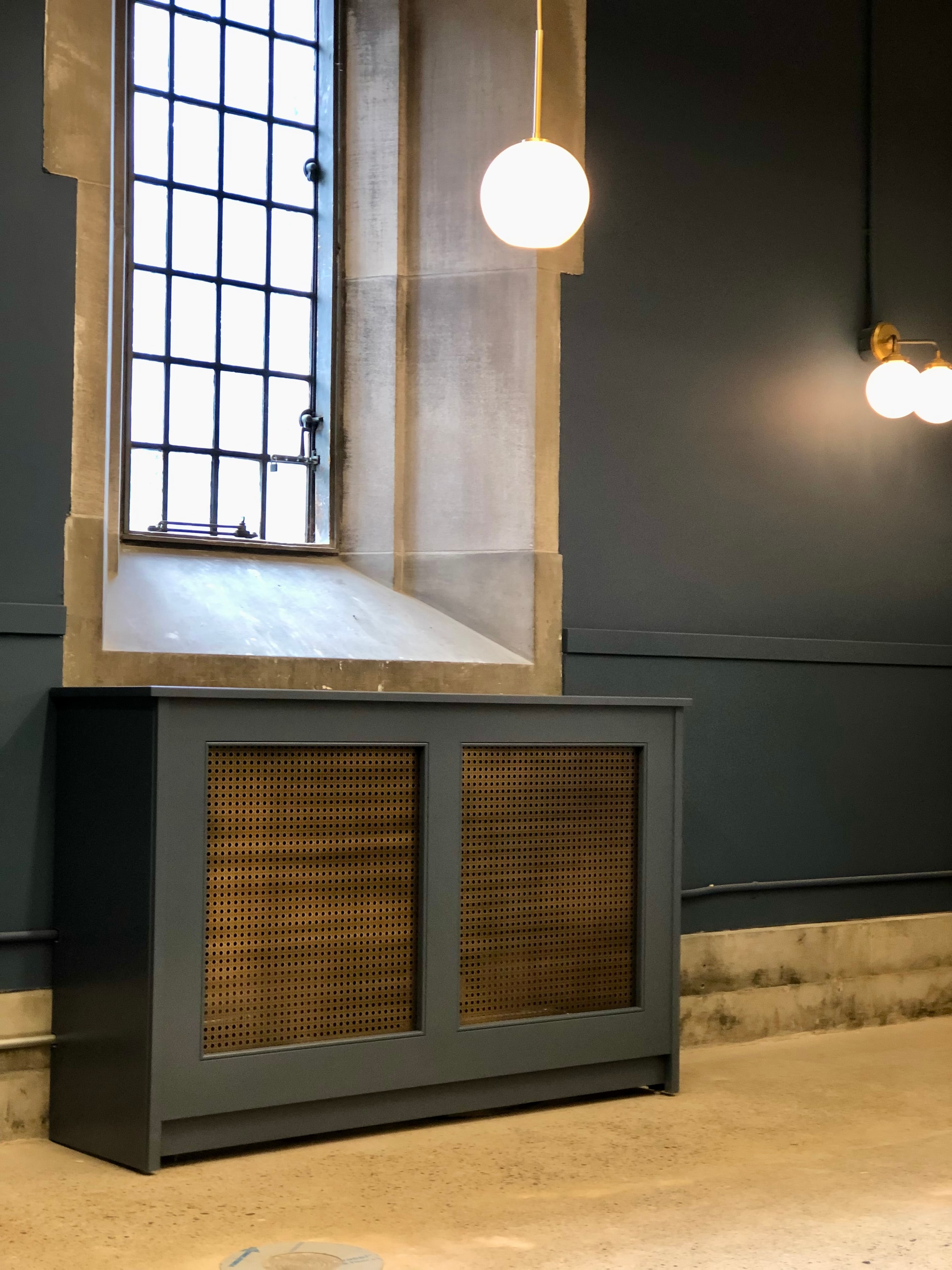 Custom radiator cover in dramatic dark interior